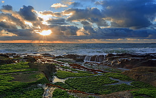 waterfall near green grasses photo taken during golden hour