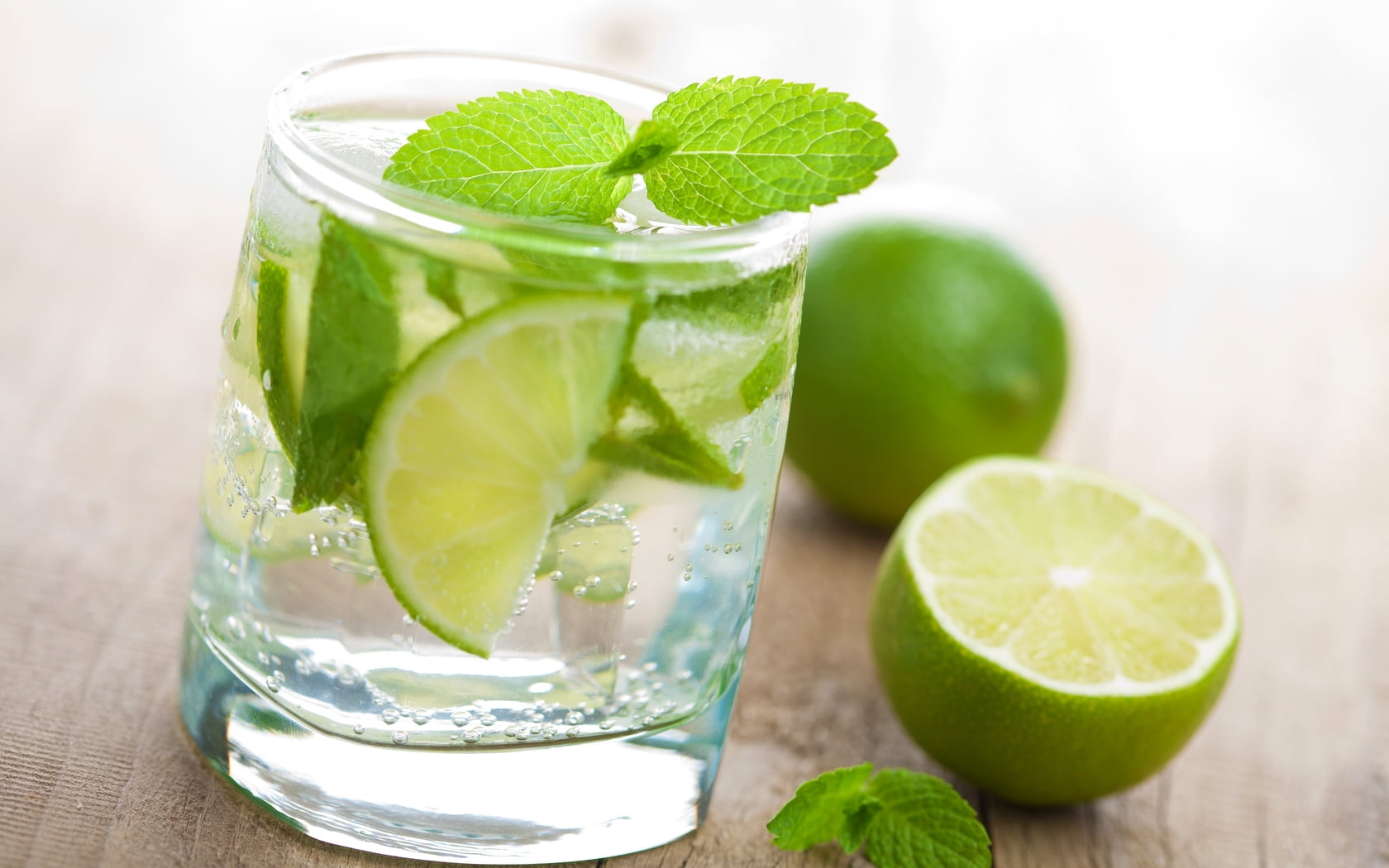 slices of lemon and mint leaf on glass