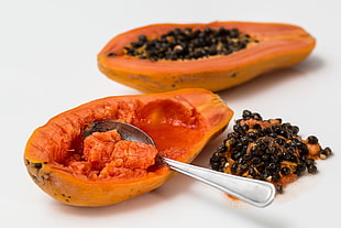 orange papaya fruit with stainless steel spoon HD wallpaper