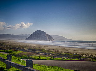 photo of mountain near to body of water