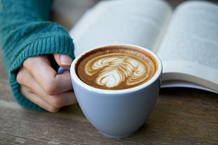 white ceramic cup with cappuccino