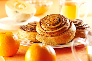 three brown rolled cinnamon breads