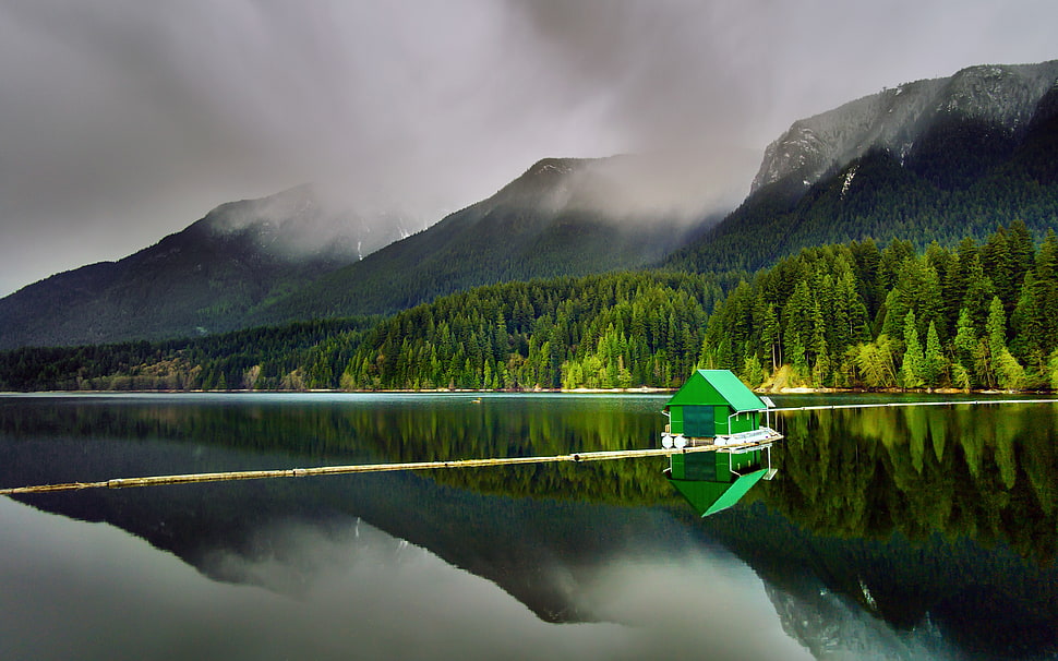 green wooden boat under gray skies during daytime HD wallpaper