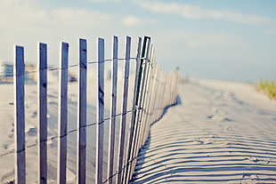 white wooden fence during winter