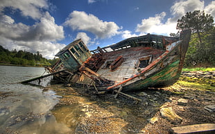 wrecked brown and green boat under cloudy blue sky during daytime HD wallpaper