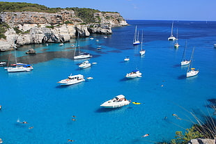 white speedboats on blue seat under blue sky