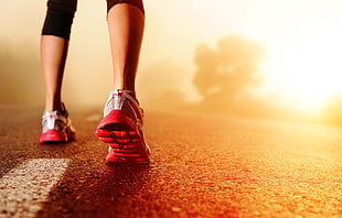 woman wears red running shoes on street