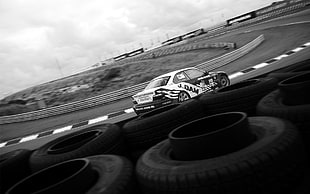 gray scale photography of racing car on race track