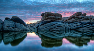 rock formation on body of water during daytime HD wallpaper