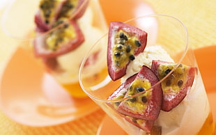 selective focus photography of sliced passion fruit with ice cream