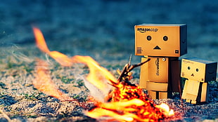 two box mans sad face front of bonfire