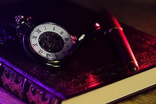 round silver-colored pocket watch