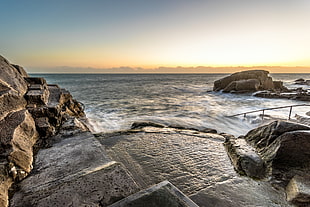 rocks and body of water during golden time