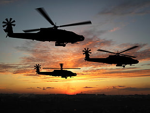 silhouette photo of three helicopters during golden hour HD wallpaper