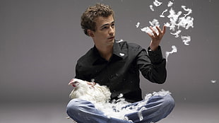 man holding hen and feathers HD wallpaper