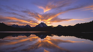 mountain under orange and blue sky HD wallpaper