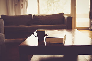 photo of black ceramic mug near book on wooden table HD wallpaper