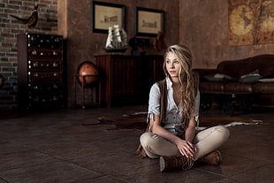 woman in white button-up shirt sitting inside room