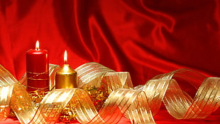 two lighted red and beige candles HD wallpaper