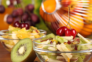 closeup photo of cherry on top of kiwi salad in bowl