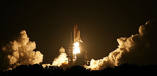 Space shuttle taking off during night time