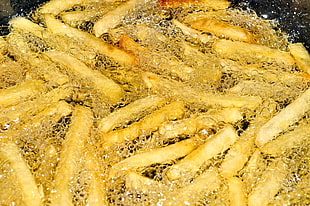 Potato fries dip in boiling oil HD wallpaper