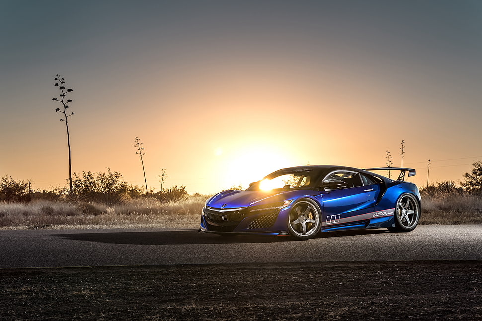 photo of blue luxury car on empty road against the sun HD wallpaper