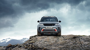 gray Land Rover Range Rover on the brown rock in daytime