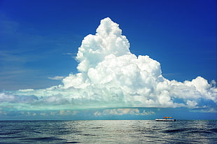 white boat on sea with view of columbus clouds HD wallpaper