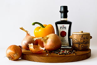 still-life photo of onions, bell pepper, Fini bottle and brown canister on brown wooden surface HD wallpaper