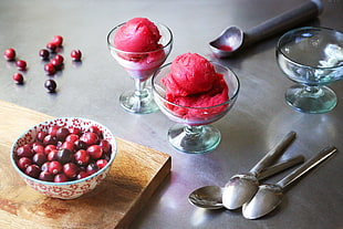 two clear glass footed bowls with redberries