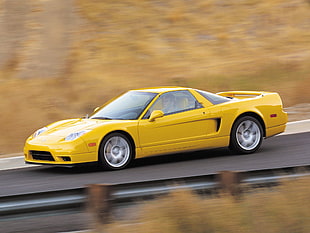 yellow sport car on road