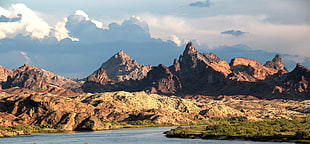 brown mountains under the white cloudy sky