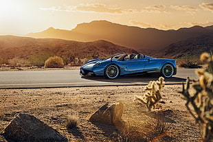 blue Pagani Huayra Roadster running on road during daytime HD wallpaper