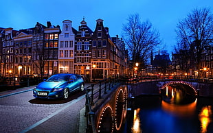 blue car near building at night