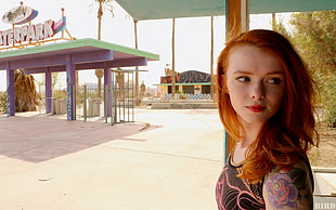 woman wearing black and purple floral top taking picture during daytime