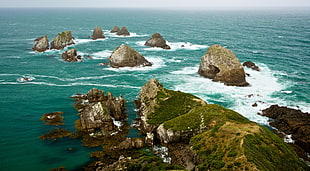 rock formation on body of water