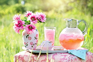 pink petaled flower in white and pink floral vase beside glass pitcher and drinking glass on tray HD wallpaper
