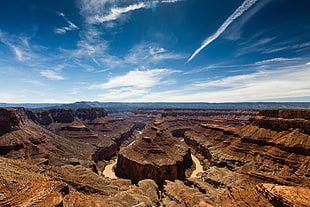 rock formation under white cloud blue skies