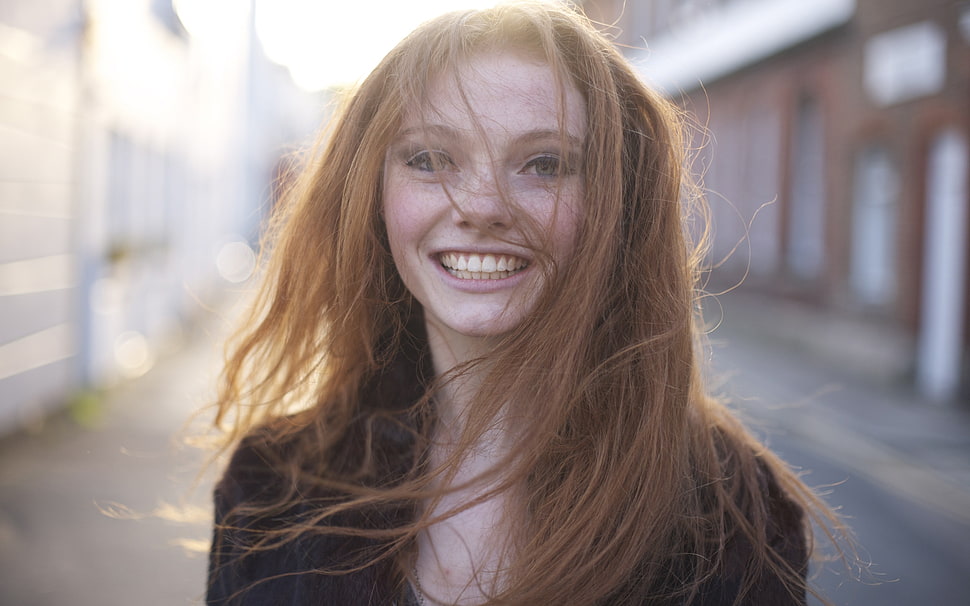 woman wearing black shirt smiling close-up photography HD wallpaper