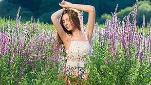 woman in white and pink spaghetti strap dress posing on purple lavender field