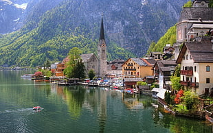 Photography of gray concrete church near body of water