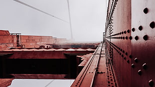 white and black metal frame, mist, sunlight, bridge, red