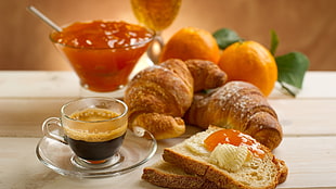 glass coffee mug with saucer and toasted bread with cream