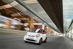 white and red 3-door hatchback on black asphalt road