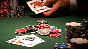 Poker chip and cards on green table