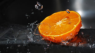 slice Orange Fruit with water splash and droplets