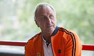 man in orange jacket photo