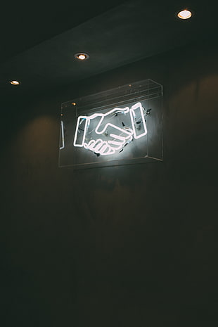 white human hands neon light signage