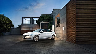 white Volvo sedan parked near concrete building at nighttime HD wallpaper